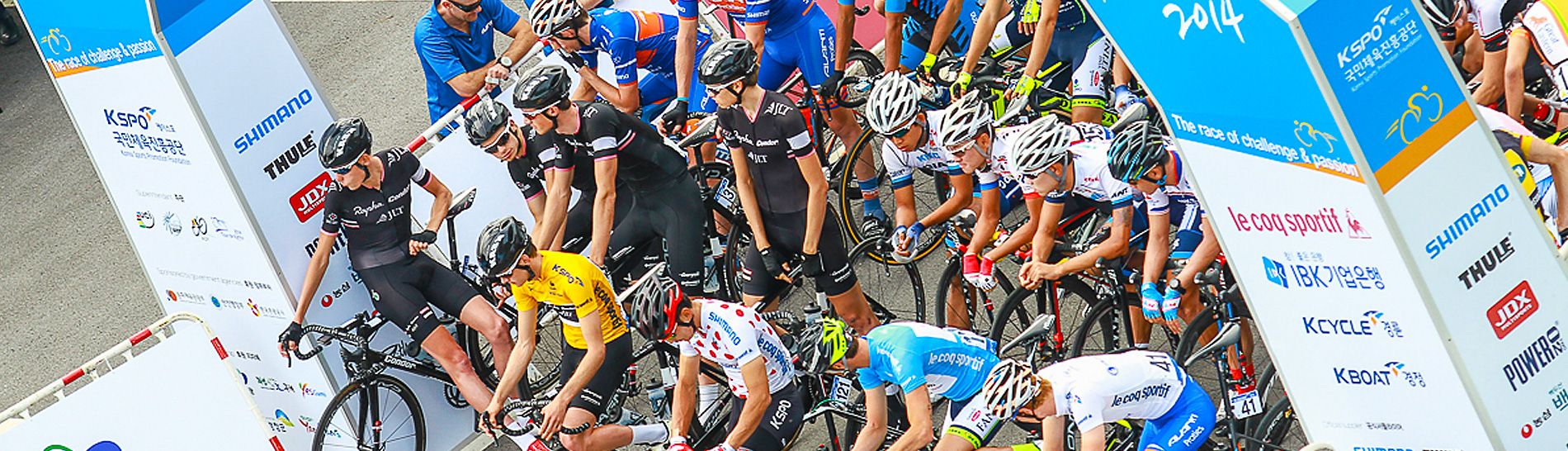 Tour de Korea: Start gantry showing sponsor branding and riders awaiting the start