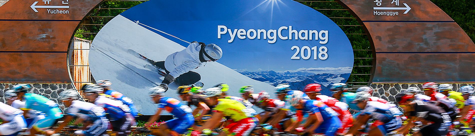 Tour de Korea: riders pass an Winter Olympic Games sign